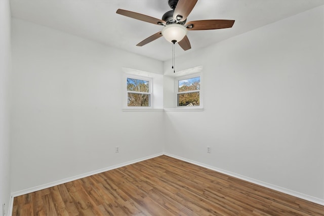 empty room featuring hardwood / wood-style floors and ceiling fan