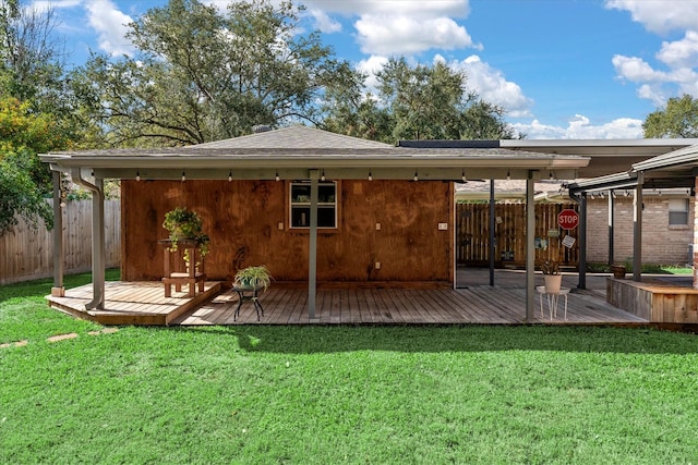 back of house with a wooden deck and a yard