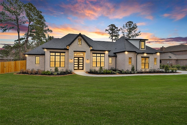 french country inspired facade with a lawn