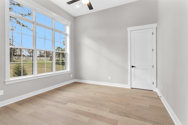 spare room featuring ceiling fan and light wood-type flooring