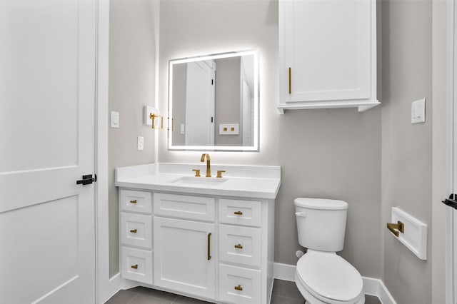 bathroom featuring tile patterned flooring, vanity, and toilet