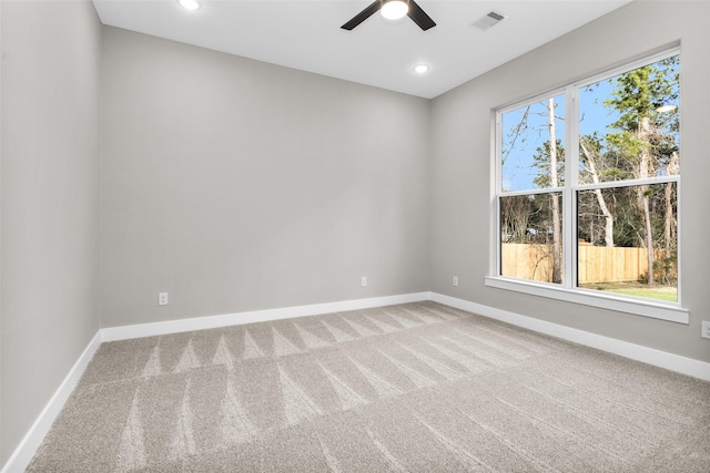 carpeted spare room with ceiling fan