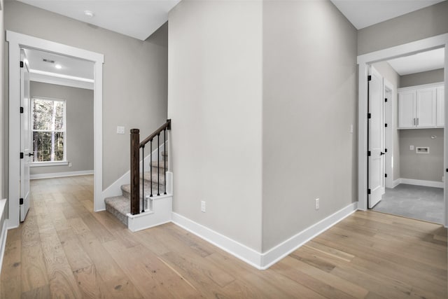 corridor with light hardwood / wood-style floors