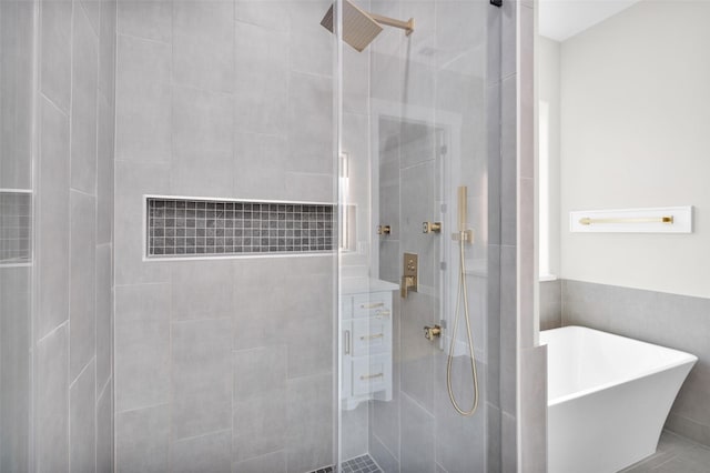 bathroom featuring separate shower and tub