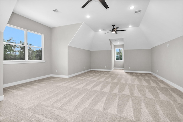 additional living space with ceiling fan, lofted ceiling, and light carpet