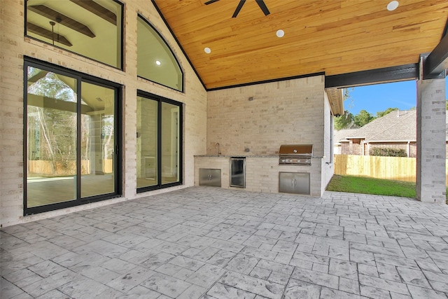 view of patio featuring ceiling fan, an outdoor kitchen, sink, and grilling area