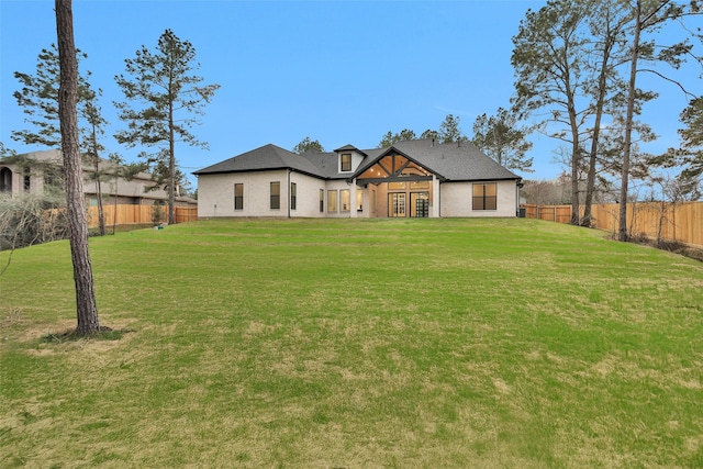 back of house featuring a lawn