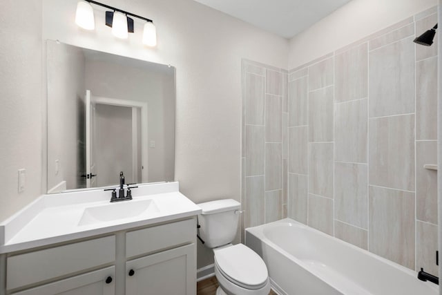 full bathroom featuring vanity, bathtub / shower combination, and toilet