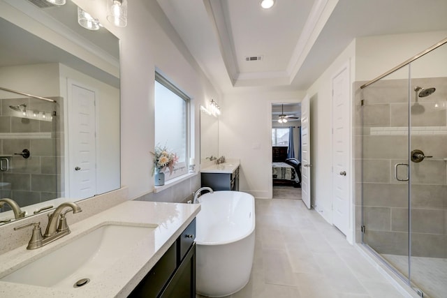 bathroom featuring independent shower and bath, vanity, a raised ceiling, and crown molding