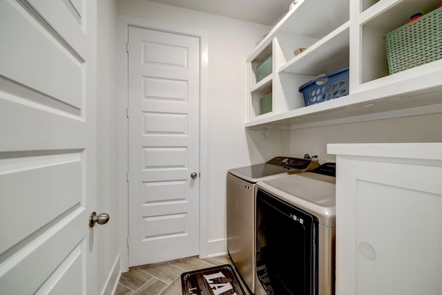 clothes washing area featuring washing machine and dryer and light hardwood / wood-style flooring