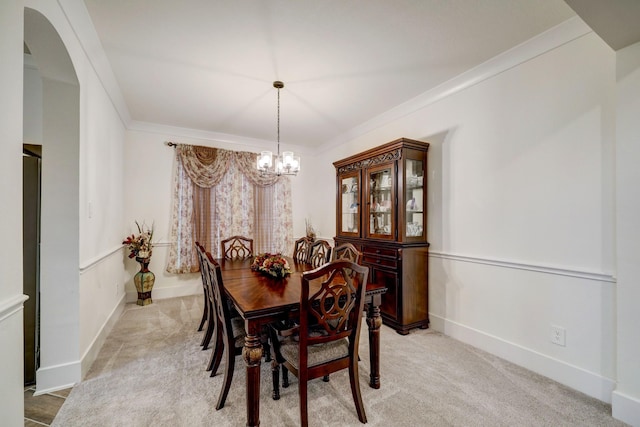 carpeted dining space with crown molding and a notable chandelier