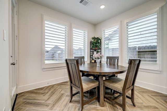 dining room featuring a wealth of natural light and light parquet floors