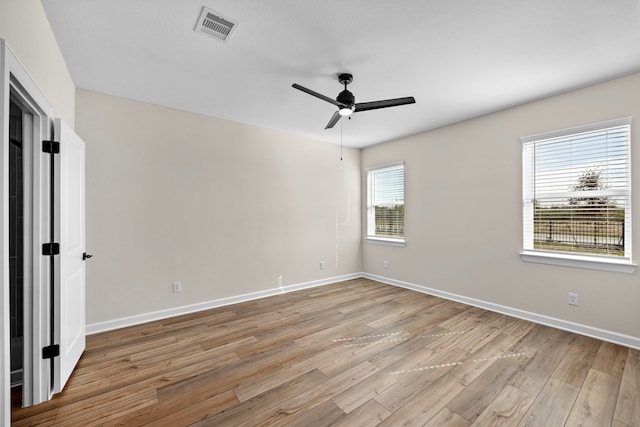 spare room with ceiling fan and light wood-type flooring