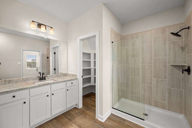 bathroom with vanity, hardwood / wood-style floors, and walk in shower