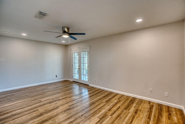 spare room featuring french doors, ceiling fan, and light hardwood / wood-style flooring