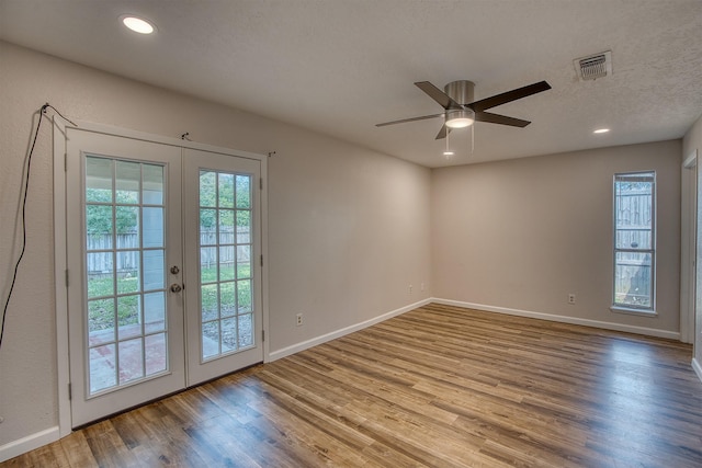 doorway with ceiling fan, french doors, a textured ceiling, and light wood-type flooring