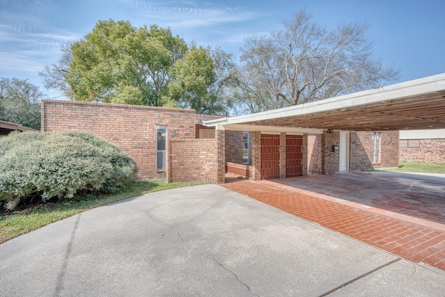 view of side of home with a carport