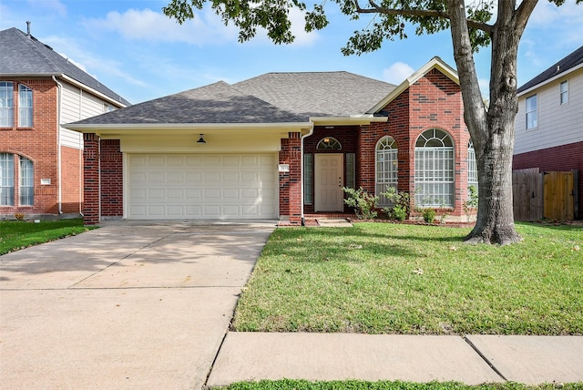 front facade featuring a garage and a front lawn