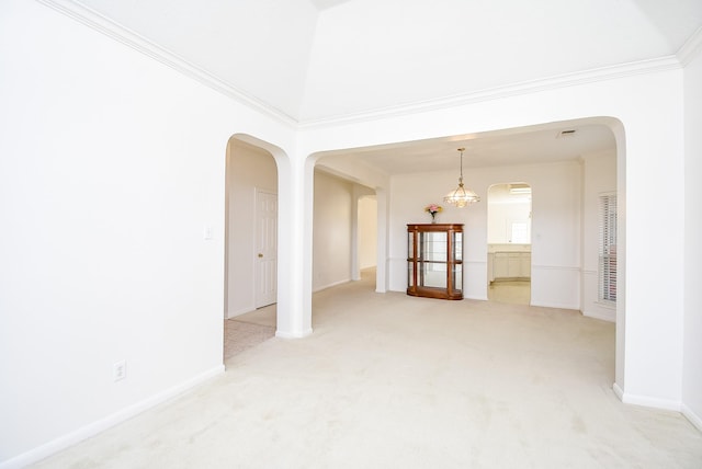 unfurnished room featuring a high ceiling, ornamental molding, light carpet, and a notable chandelier