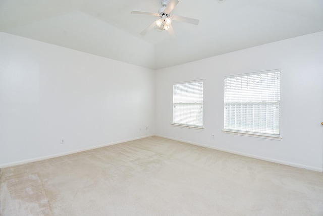 carpeted empty room with lofted ceiling and ceiling fan