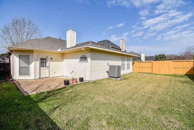 back of house featuring cooling unit, a yard, and a patio area