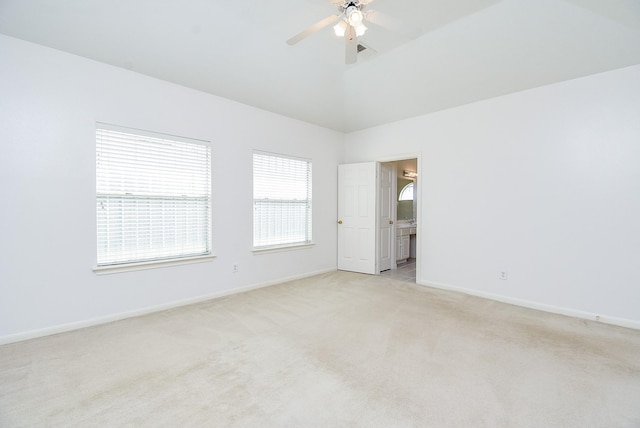 carpeted spare room featuring ceiling fan