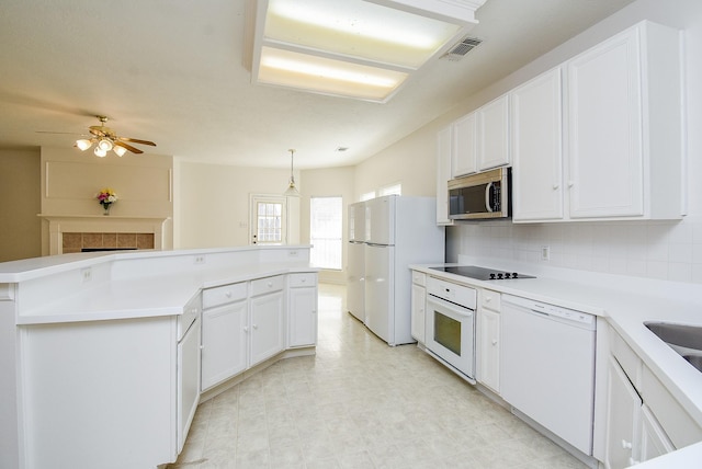 kitchen featuring white cabinetry, white appliances, decorative light fixtures, and decorative backsplash