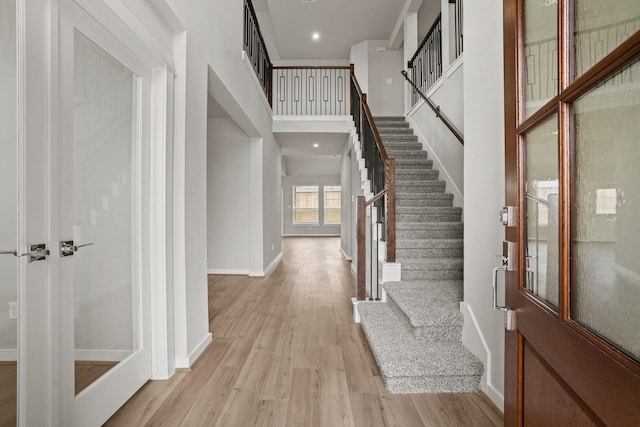 entrance foyer with light hardwood / wood-style floors and a high ceiling