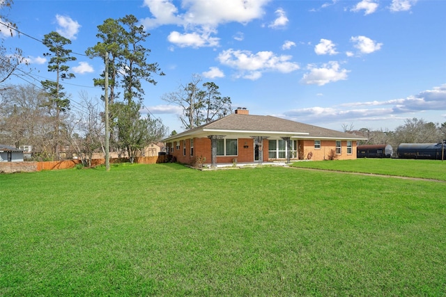 back of property featuring a yard