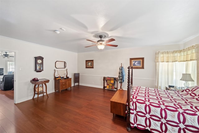 bedroom with dark wood-type flooring, ceiling fan, and crown molding