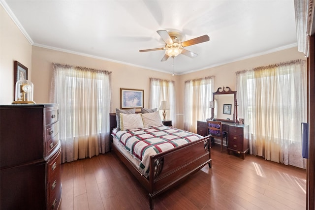 bedroom with ceiling fan, ornamental molding, and dark hardwood / wood-style floors