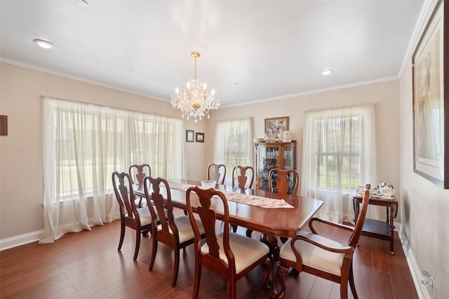 dining space featuring crown molding, dark hardwood / wood-style flooring, and an inviting chandelier