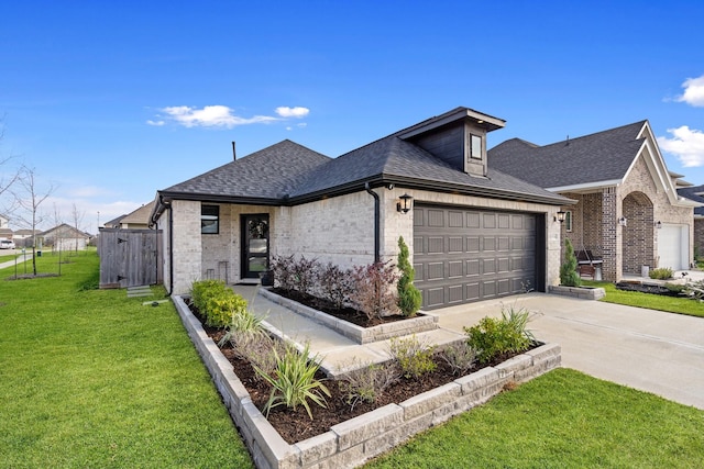 view of front facade with a garage and a front lawn