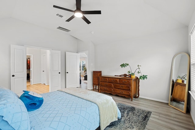 bedroom featuring ceiling fan, lofted ceiling, and light wood-type flooring