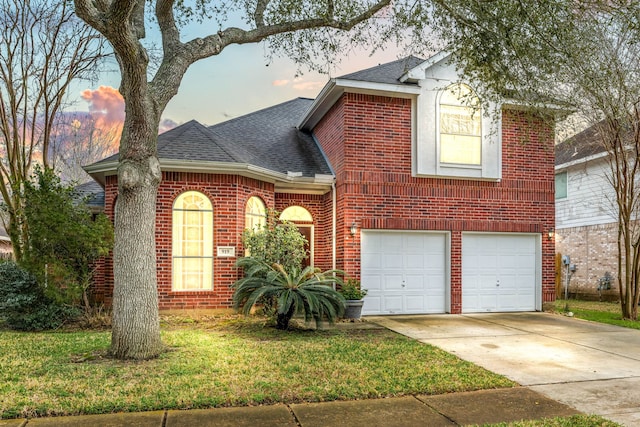 view of front of house with a garage and a lawn