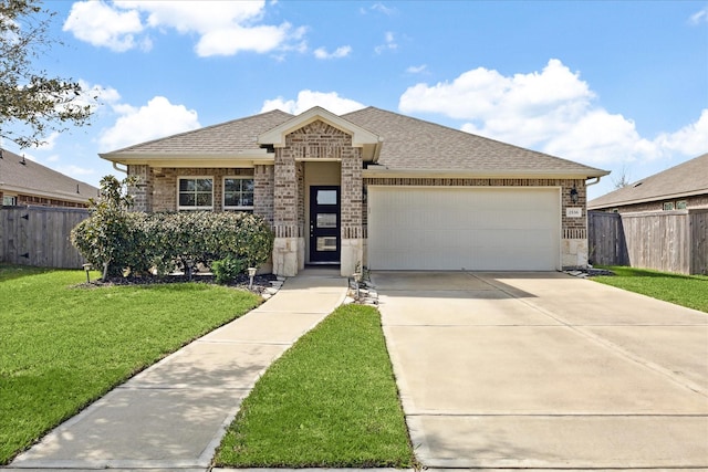 view of front of home with a garage and a front lawn