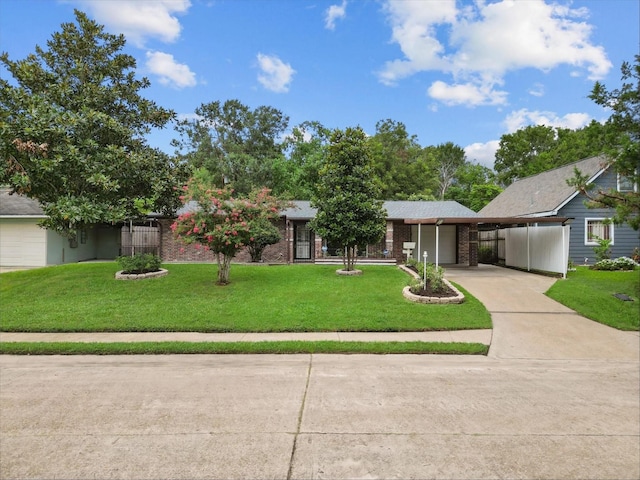 view of front of property with a front lawn and a carport