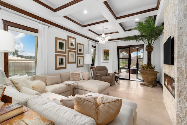 living room with a wealth of natural light, coffered ceiling, a fireplace, and stone tile floors