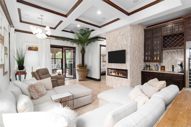 146 La Vie Dr, Montgomery, TX 77316 - living room with coffered ceiling, crown molding, beam ceiling, a large fireplace, and light tile patterned floors