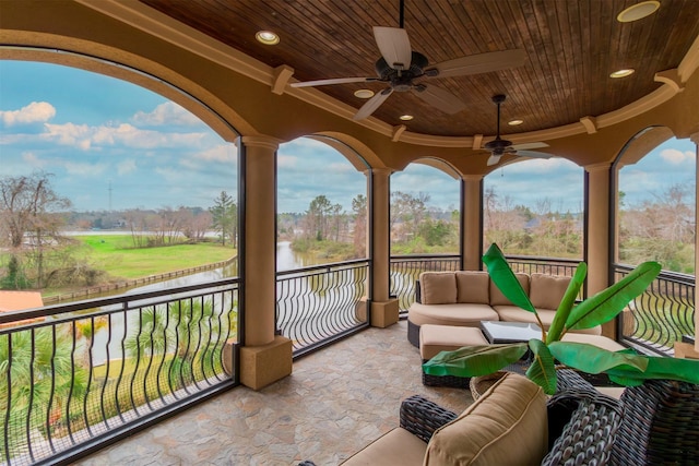 view of patio featuring ceiling fan and a balcony