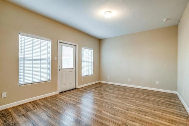 empty room with light hardwood / wood-style flooring