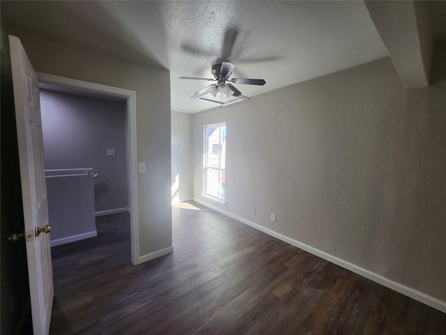 unfurnished bedroom with dark hardwood / wood-style flooring, ceiling fan, and a textured ceiling