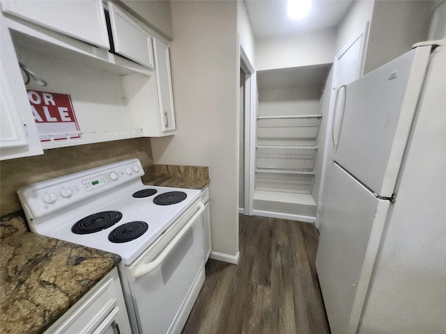 kitchen featuring white appliances, dark wood-type flooring, dark stone counters, and white cabinets