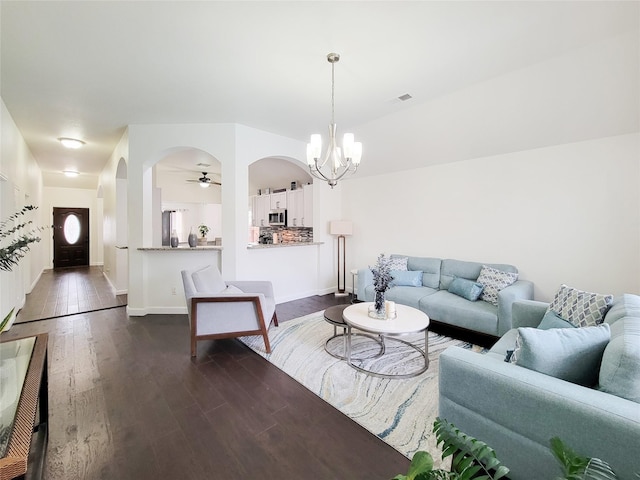 living room featuring dark hardwood / wood-style flooring and ceiling fan with notable chandelier