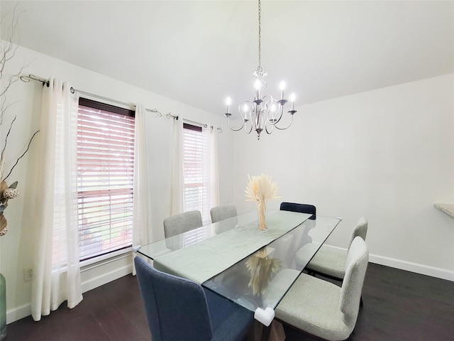 dining area with a wealth of natural light, a chandelier, dark hardwood / wood-style floors, and lofted ceiling