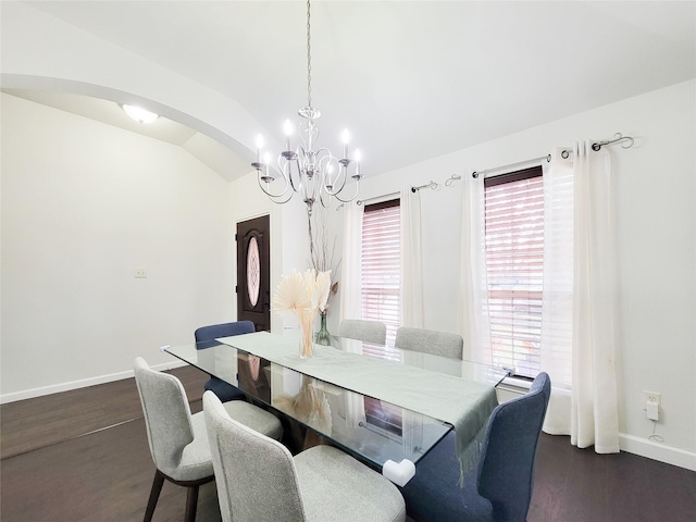 dining area with vaulted ceiling, a chandelier, and dark hardwood / wood-style floors