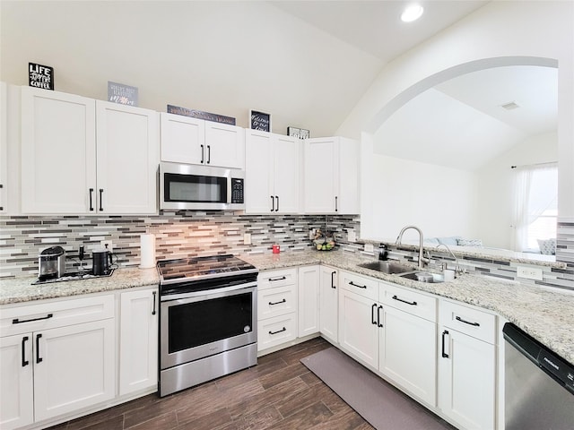 kitchen featuring white cabinetry, appliances with stainless steel finishes, sink, and lofted ceiling