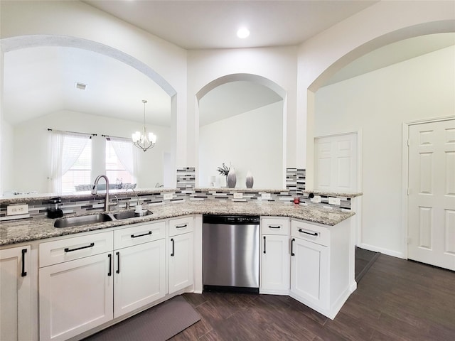 kitchen featuring hanging light fixtures, light stone counters, white cabinets, stainless steel dishwasher, and sink