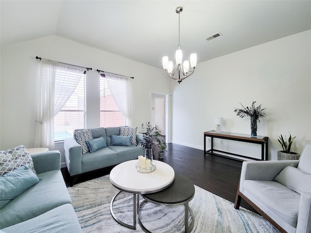 living room featuring a notable chandelier, dark hardwood / wood-style floors, and lofted ceiling