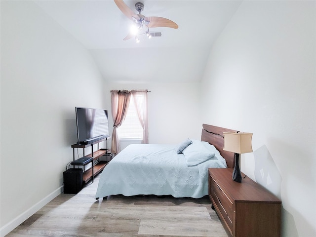 bedroom featuring light hardwood / wood-style flooring, ceiling fan, and lofted ceiling